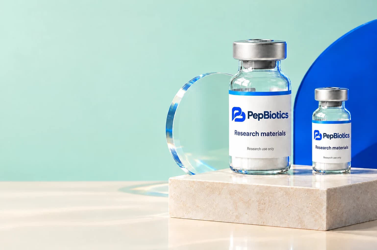 Illustrative PepBiotics research vials in a mint and cobalt studio arrangement; actual packaging varies by product